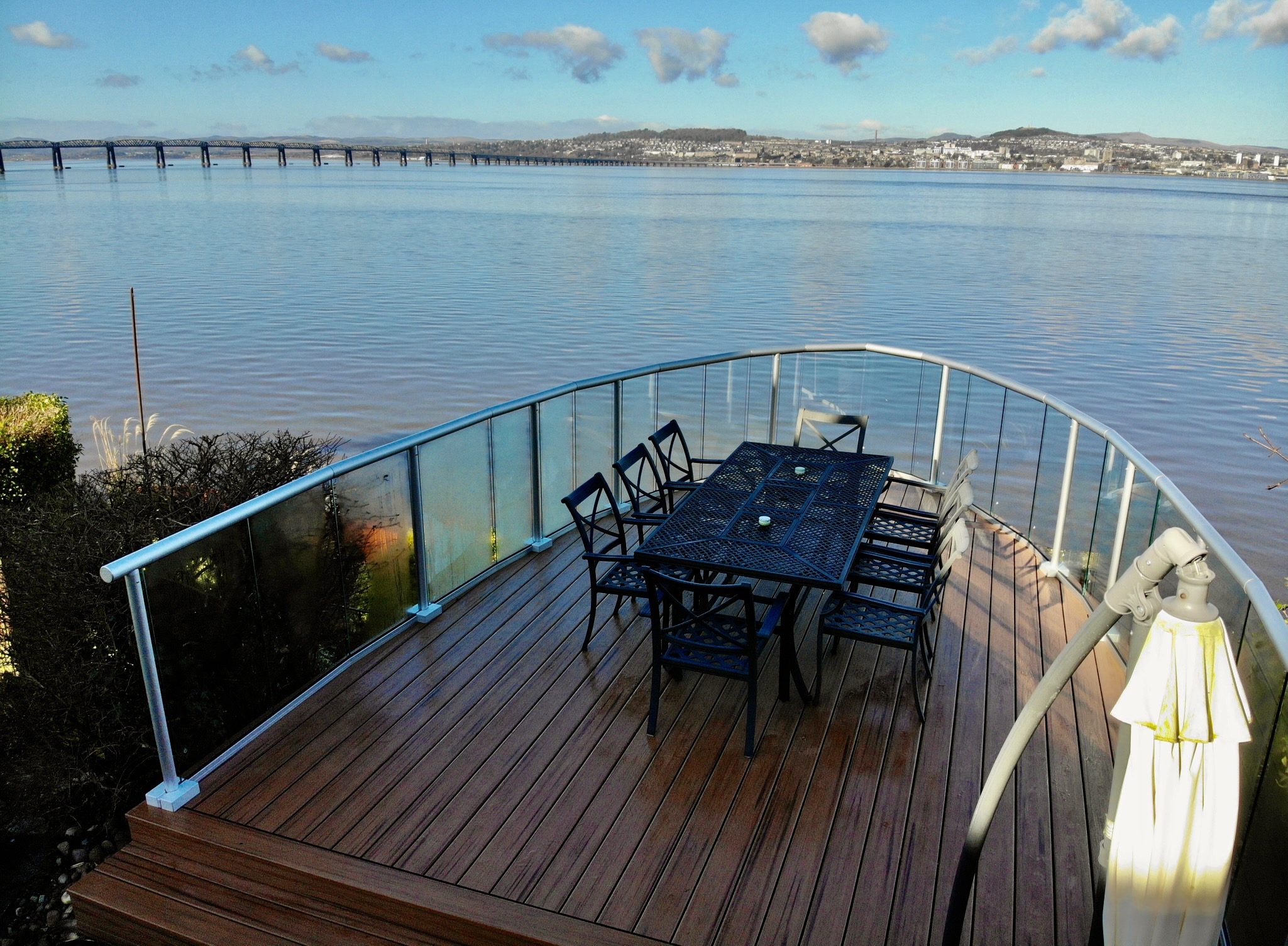 This decking was built in Newport on Tay, looking across towards Dundee. The main structure is steel and was built and installed by a local blacksmith, everything above it is C24 structural timber with deck tape, the deck board is Trex Tiki Torch. The glass rail is by Balconette and instead of it being curved its faceted, we’ve been partners with Balconette now for almost 12 years.